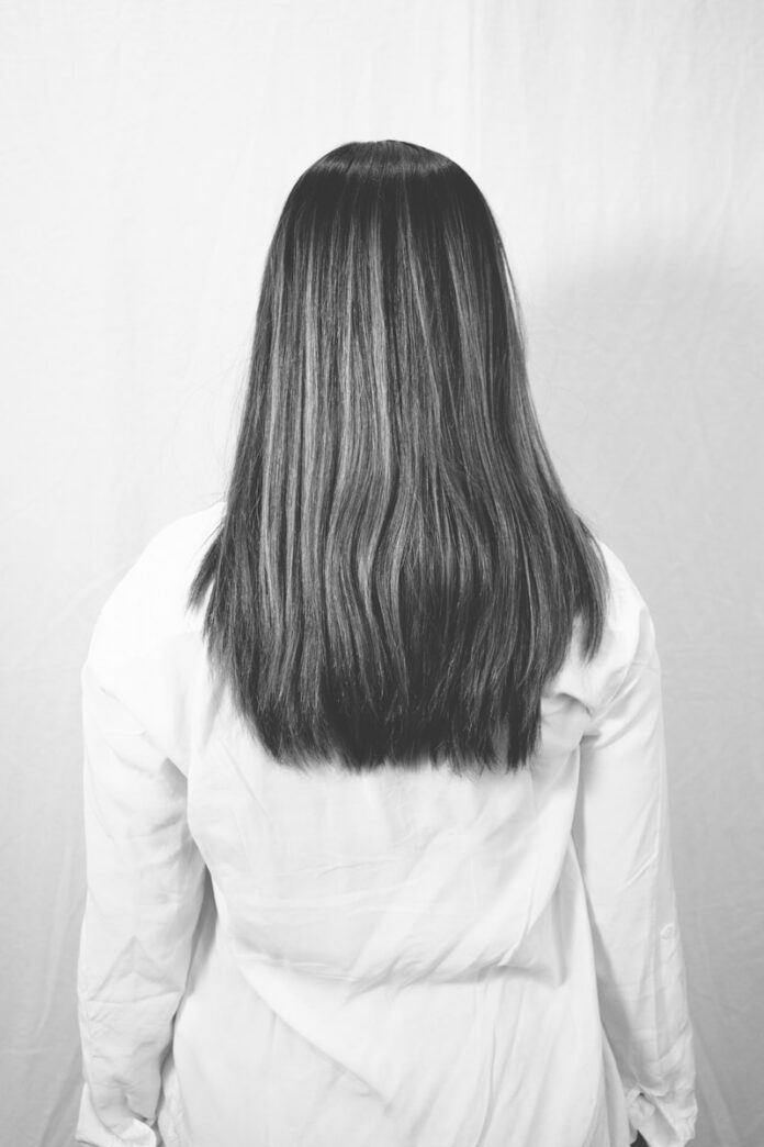 Photo by Matthew Moloney woman in white long sleeve shirt