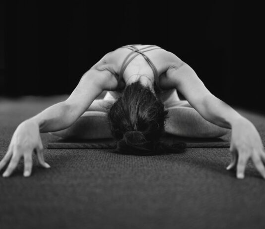 인요가(Yin): 근육보다 깊은 곳, 결합 조직을 늘리는 ‘기다림의 미학’ woman in white tank top bending her body on floor