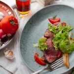 “나만의 건강 루틴, 영양제와 생활습관으로 완성하세요” meat with sliced vegetables on plate