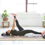 ‘웰니스 회복’의 비결, 일상에서 쉽게 실천하는 방법들 woman in black tank top and black leggings lying on black and white floral area rug