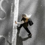 “마음 챙김 걷기”, 한국에서 번지는 새로운 건강 습관 woman in black jacket and black pants walking on gray asphalt road during daytime